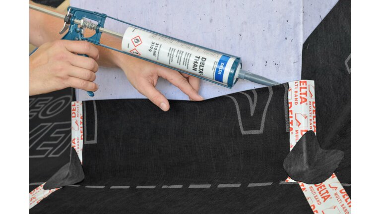 DELTA-Than Kartuschenkleber DELTA-Than Kartuschenkleber, Kartusche beim Kleben, im Vordergrund stehende Kartusche