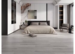 Modernes Schlafzimmer mit hellem Laminatboden in Holzoptik.